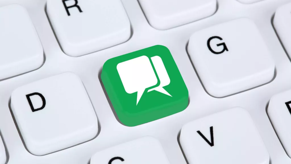 a white keyboard with a green blog key